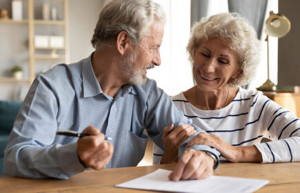 70s,couple,sit,at,table,indoor,discuss,agreement,term,and